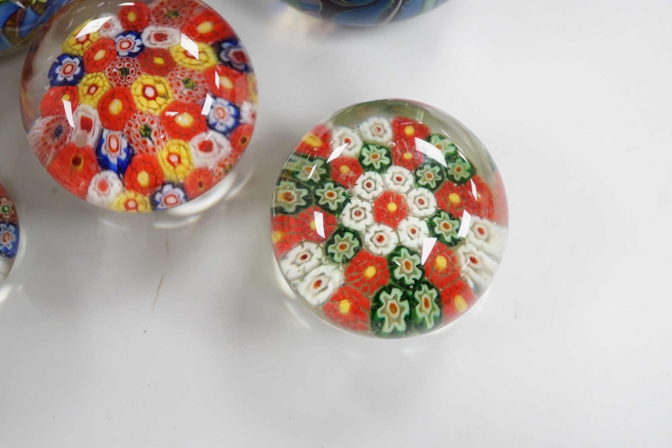 An Orient and Flume glass paperweight, a Venetian scrambled glass paperweight, and three Chinese paperweights, largest 7cm tall